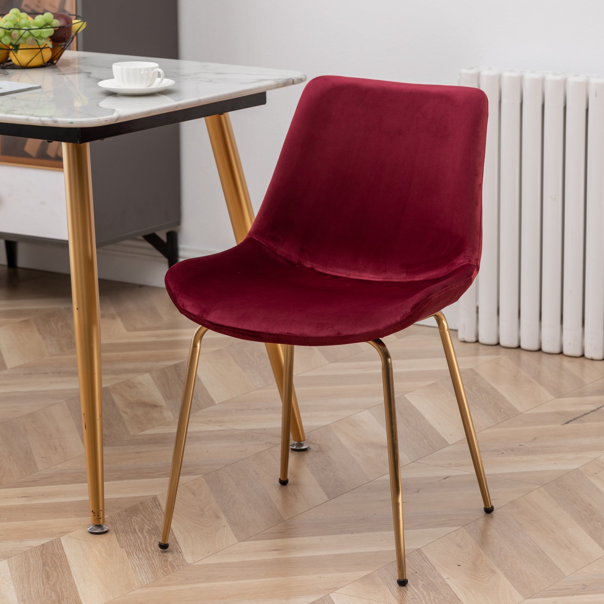 Plush burgundy velvet dining chair with sleek gold metal legs for a modern look