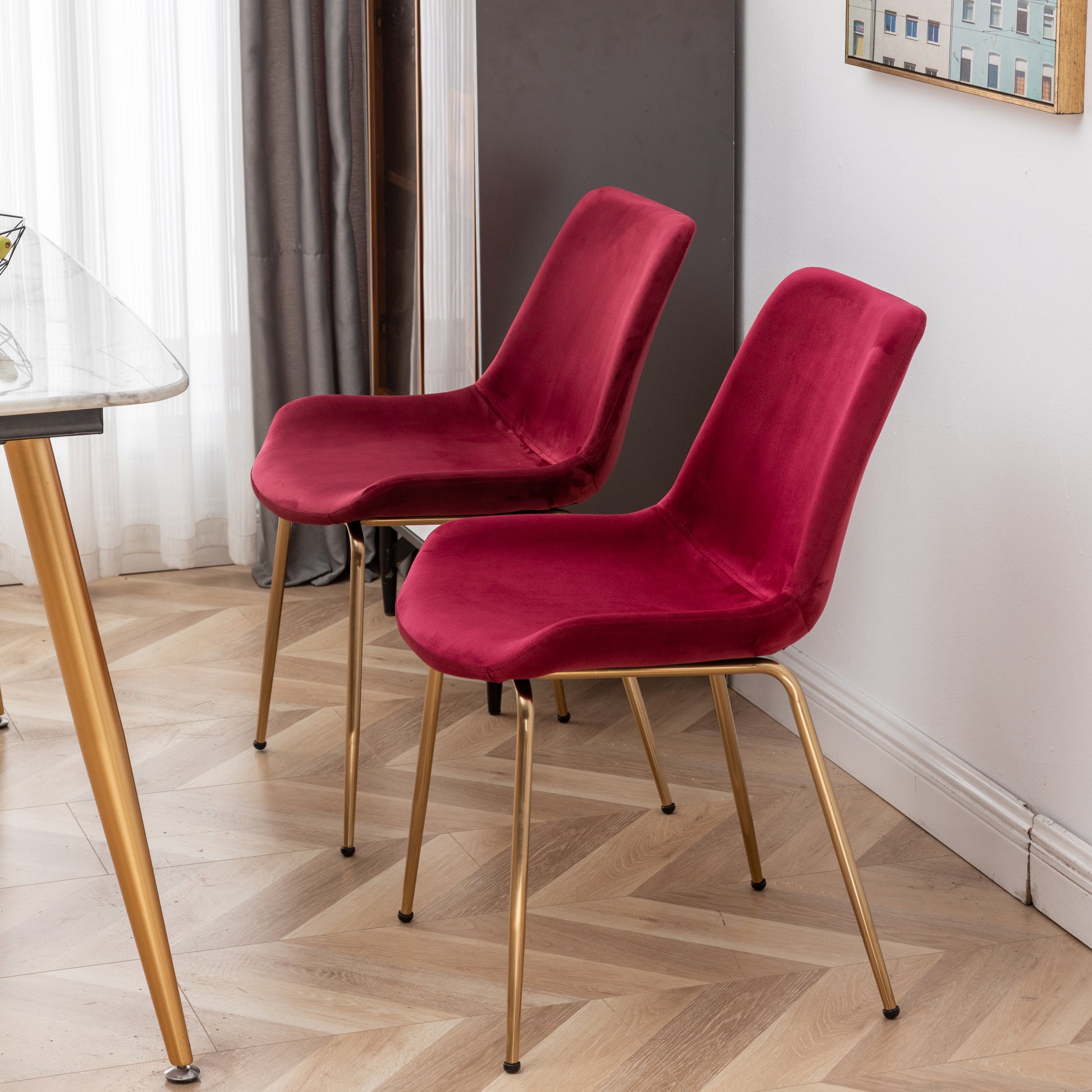 Plush crimson velvet dining chair with elegant gold legs perfect for a modern dining room