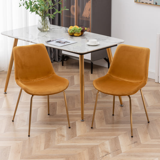 Set of two mustard yellow velvet dining chairs with gold metal legs