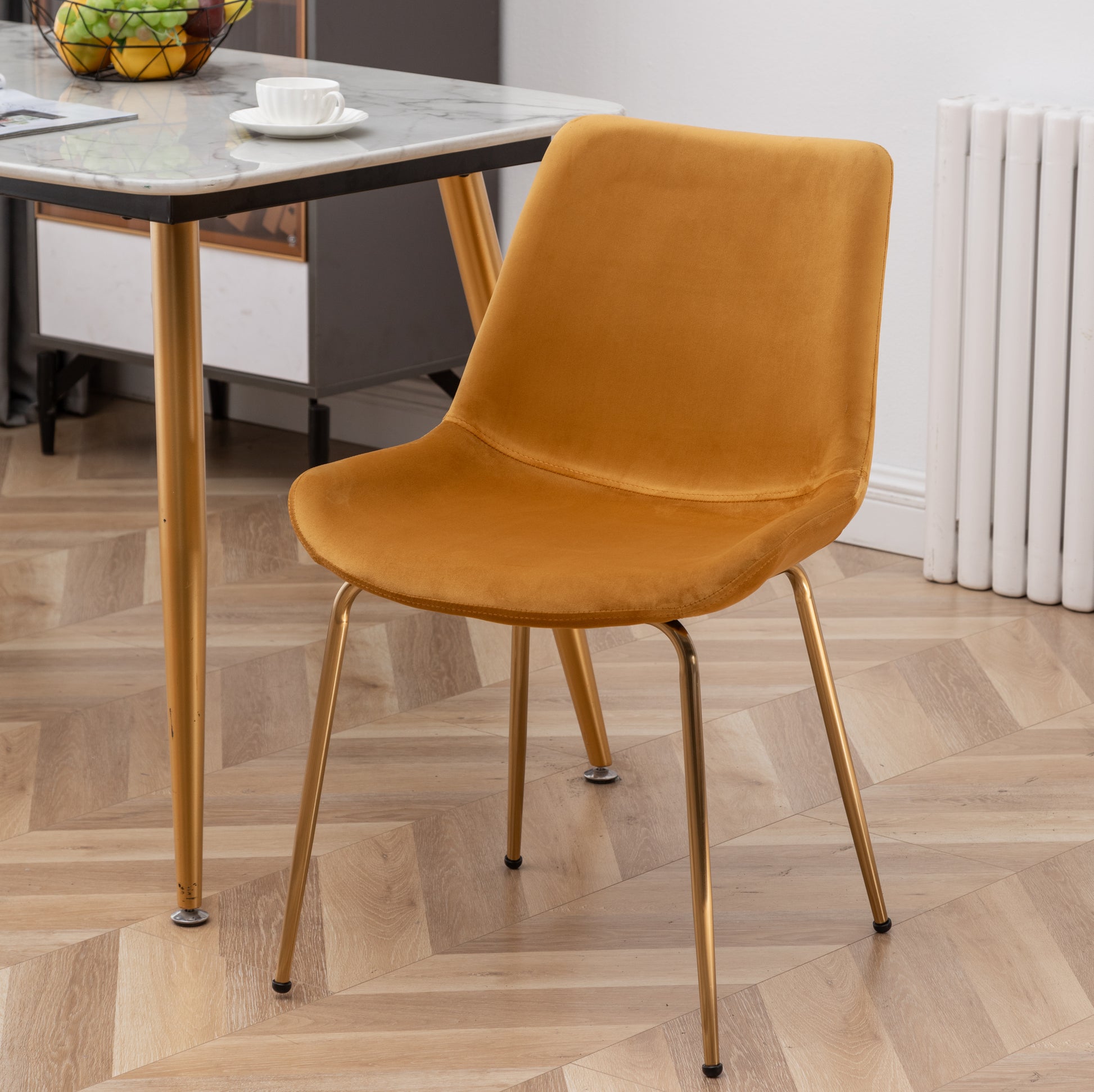 Golden velvet accent chair with modern gold legs perfect for dining areas