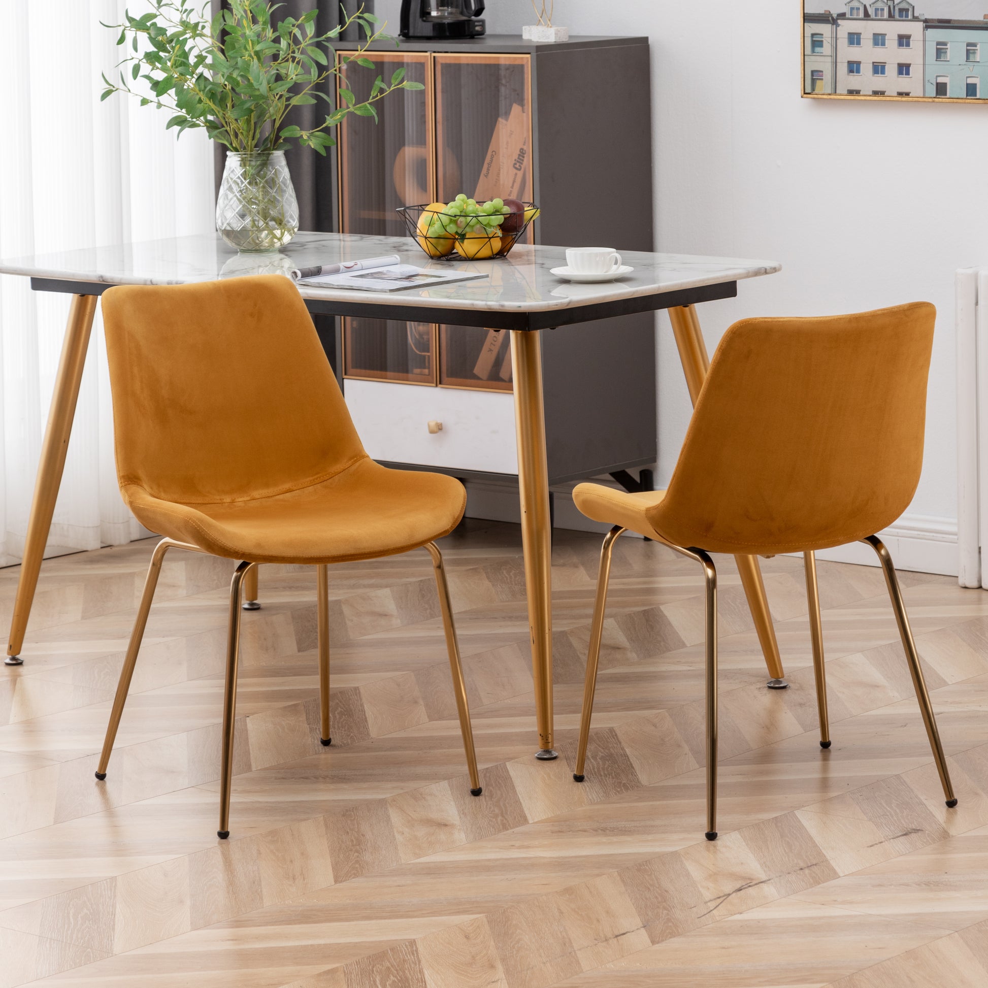 Orange velvet dining chair with gold metal legs
