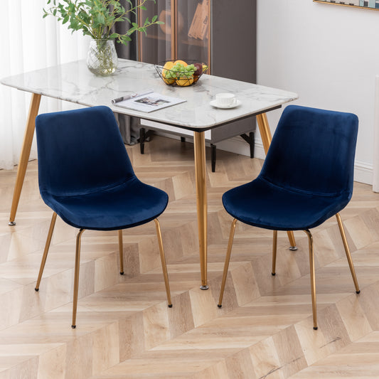 Pair of dark blue velvet dining chairs with sleek gold metal legs ideal for modern kitchens