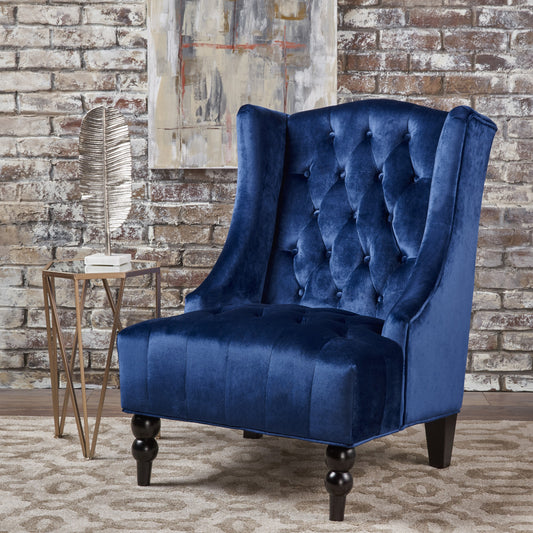 Luxurious royal blue velvet wingback accent chair with deep button tufting and dark wood legs