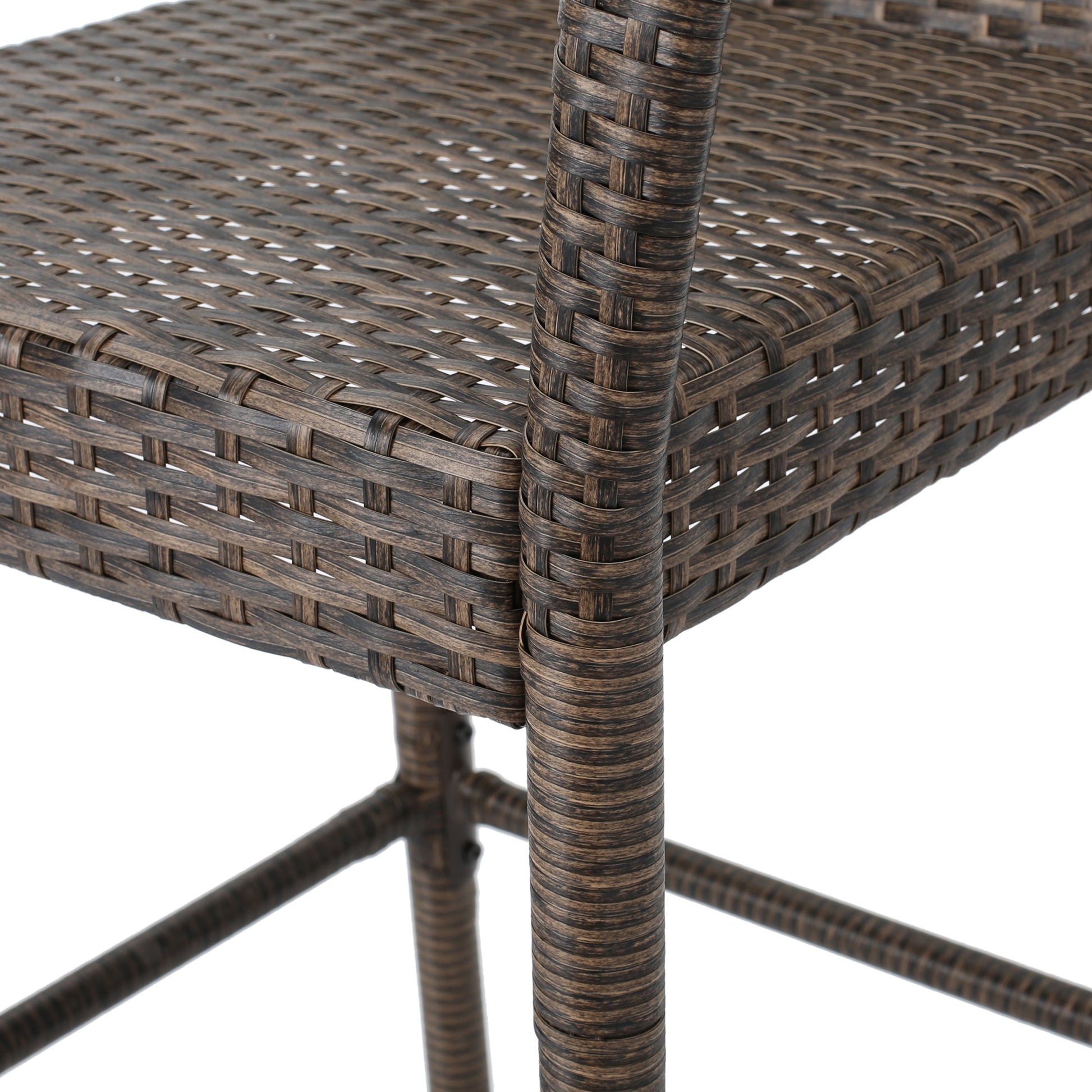 Closeup of a brown rattan bar stool seat and legs with intricate weaving detail