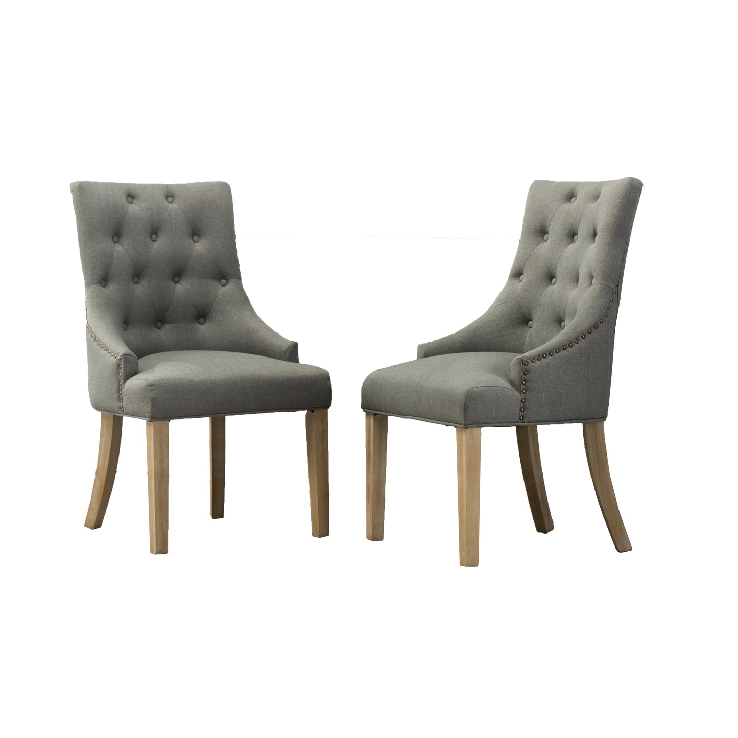 Two grey fabric dining chairs with tufted backs and brass nailhead trim