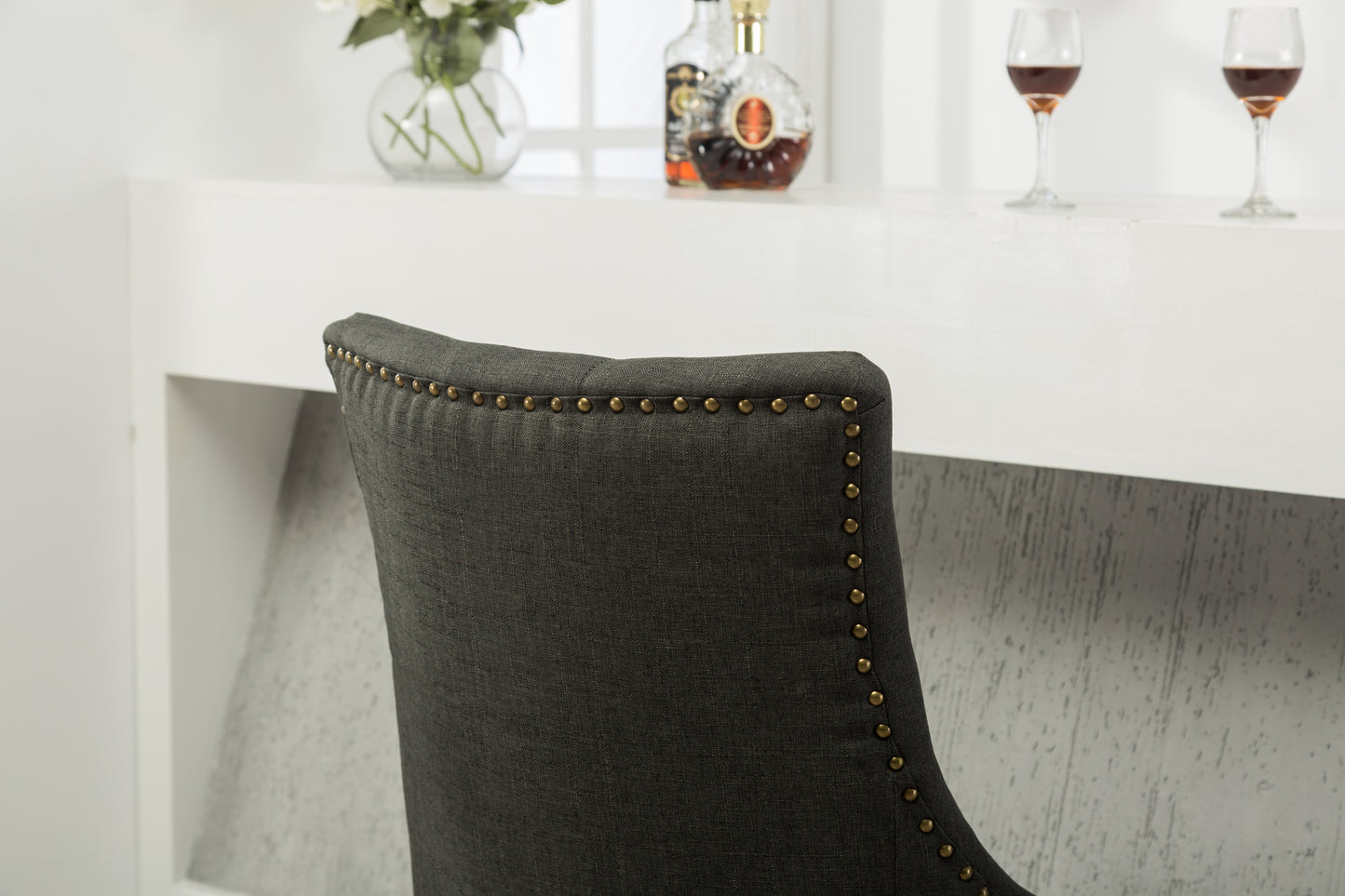 Dark grey fabric bar stool back with brass nailhead trim classic design