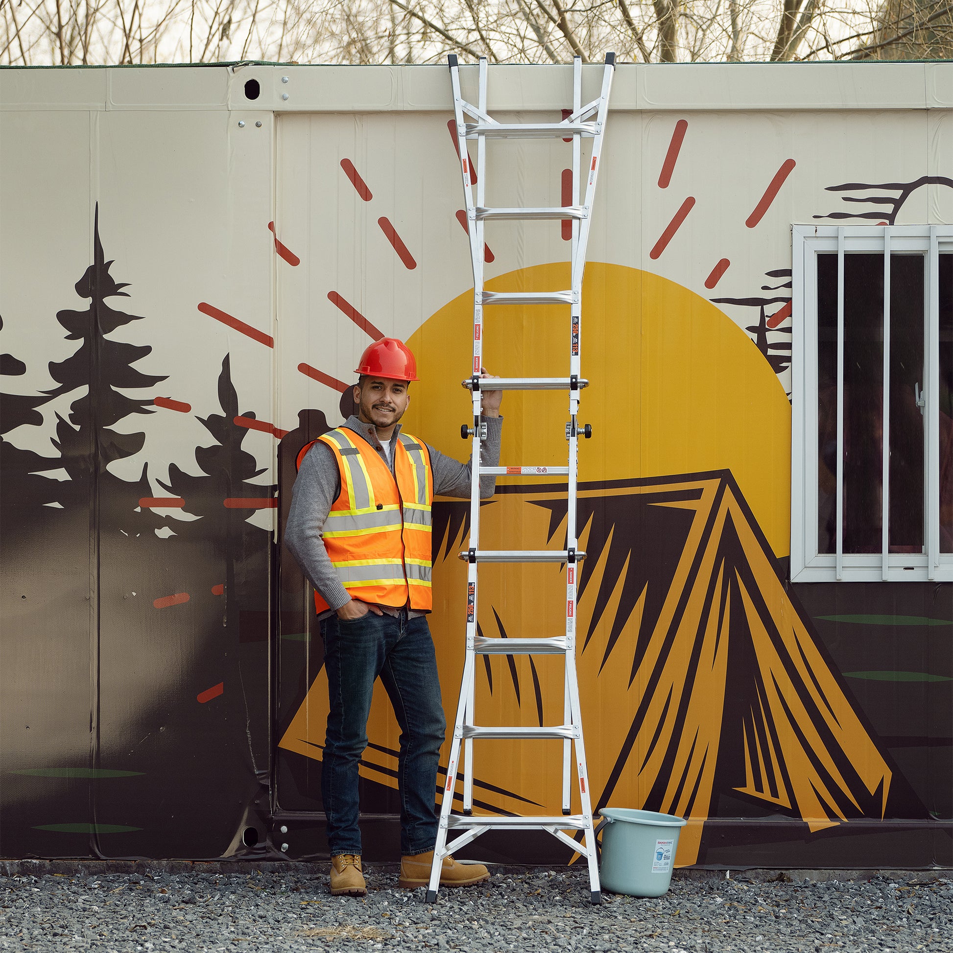 Silver multiposition ladder with a man in a safety vest ideal for construction work