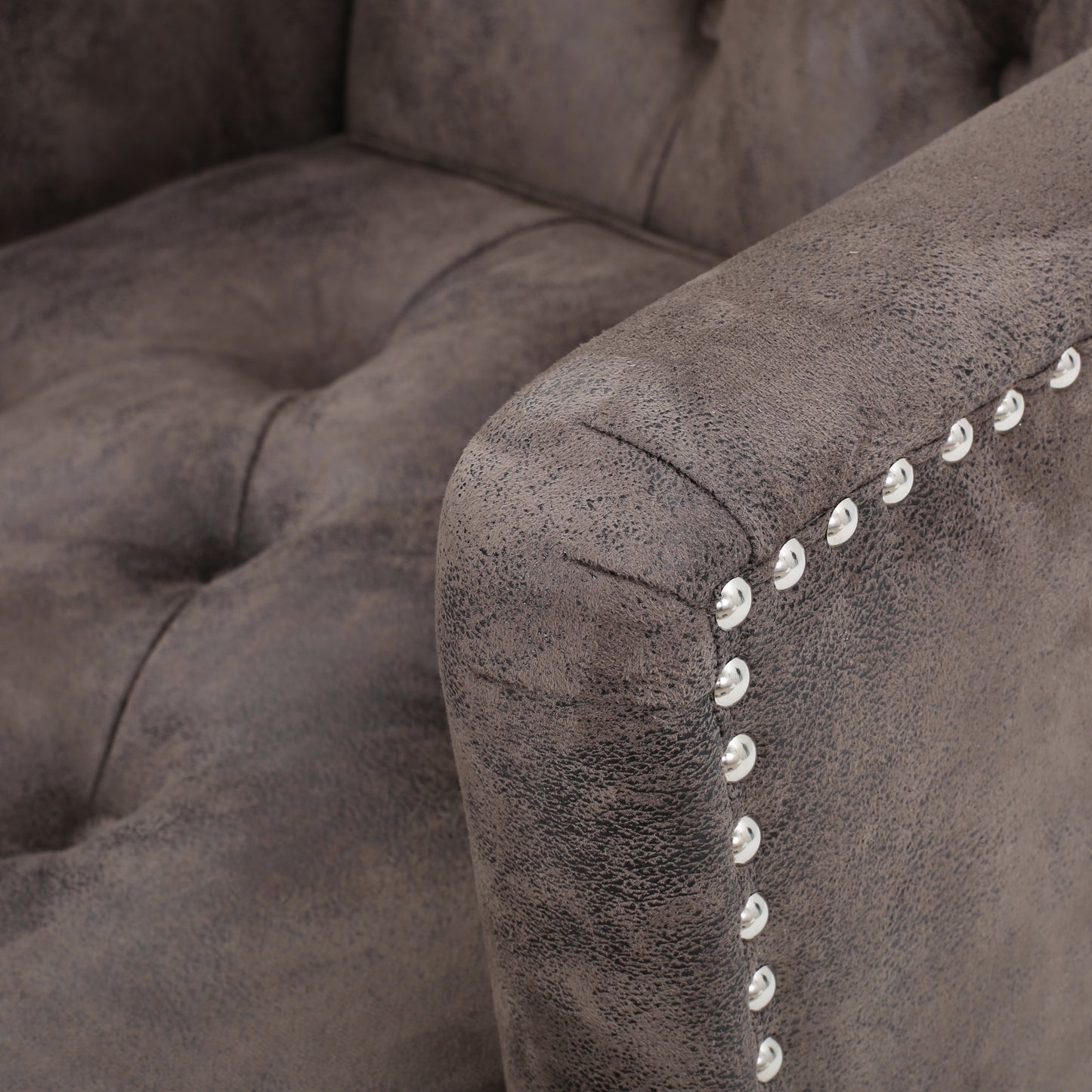 Tufted charcoal grey velvet accent chair with silver nailhead trim detailing