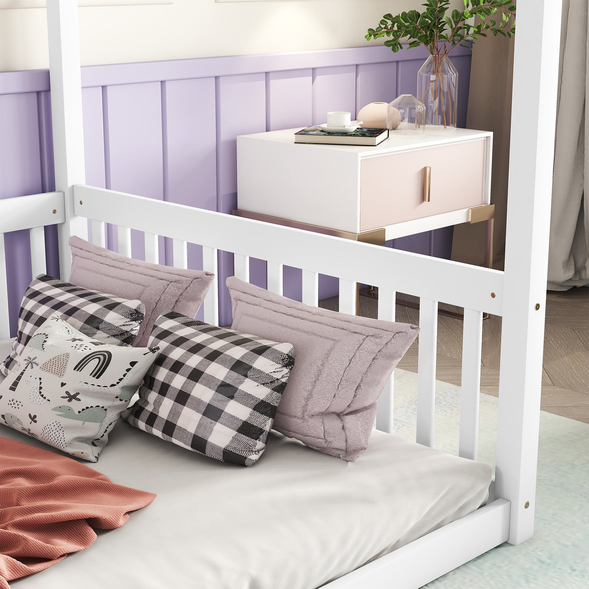 White canopy bed frame with playful dinosaur and rainbow pillows