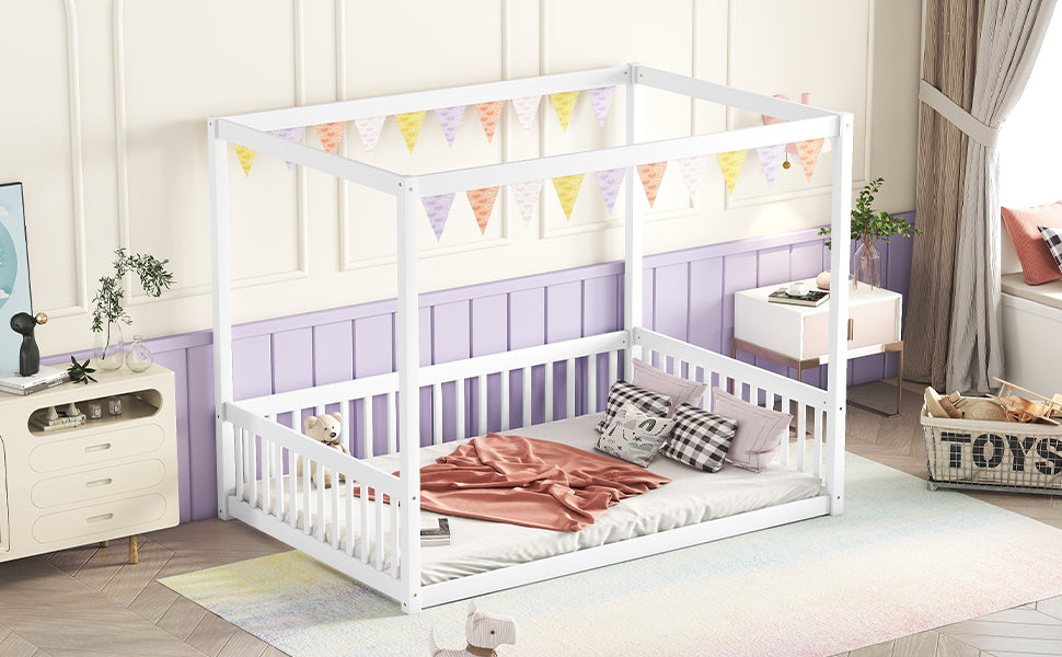 White wooden canopy bed frame with playful pastel bunting
