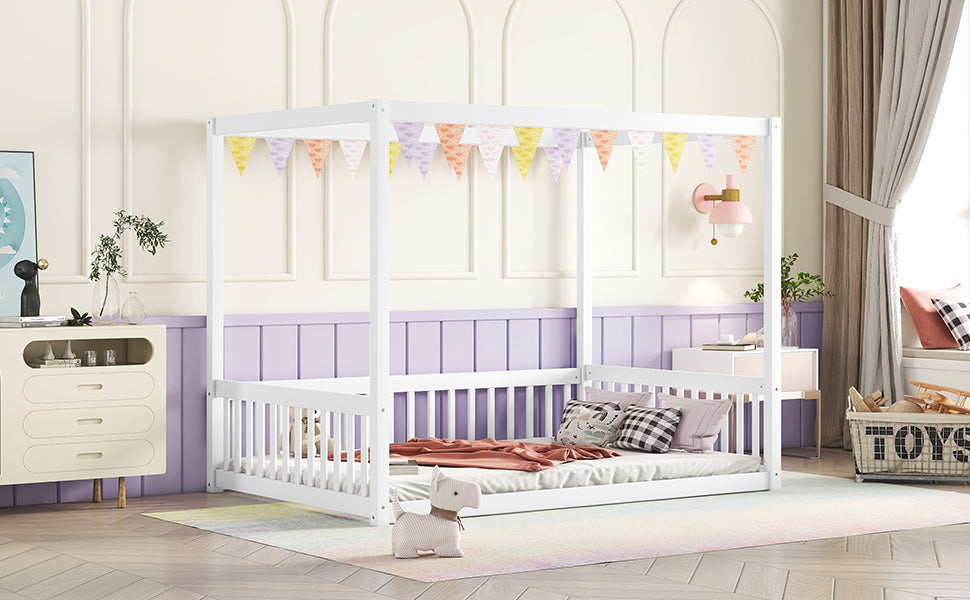 White wooden canopy bed with playful pennant banner for a childs room