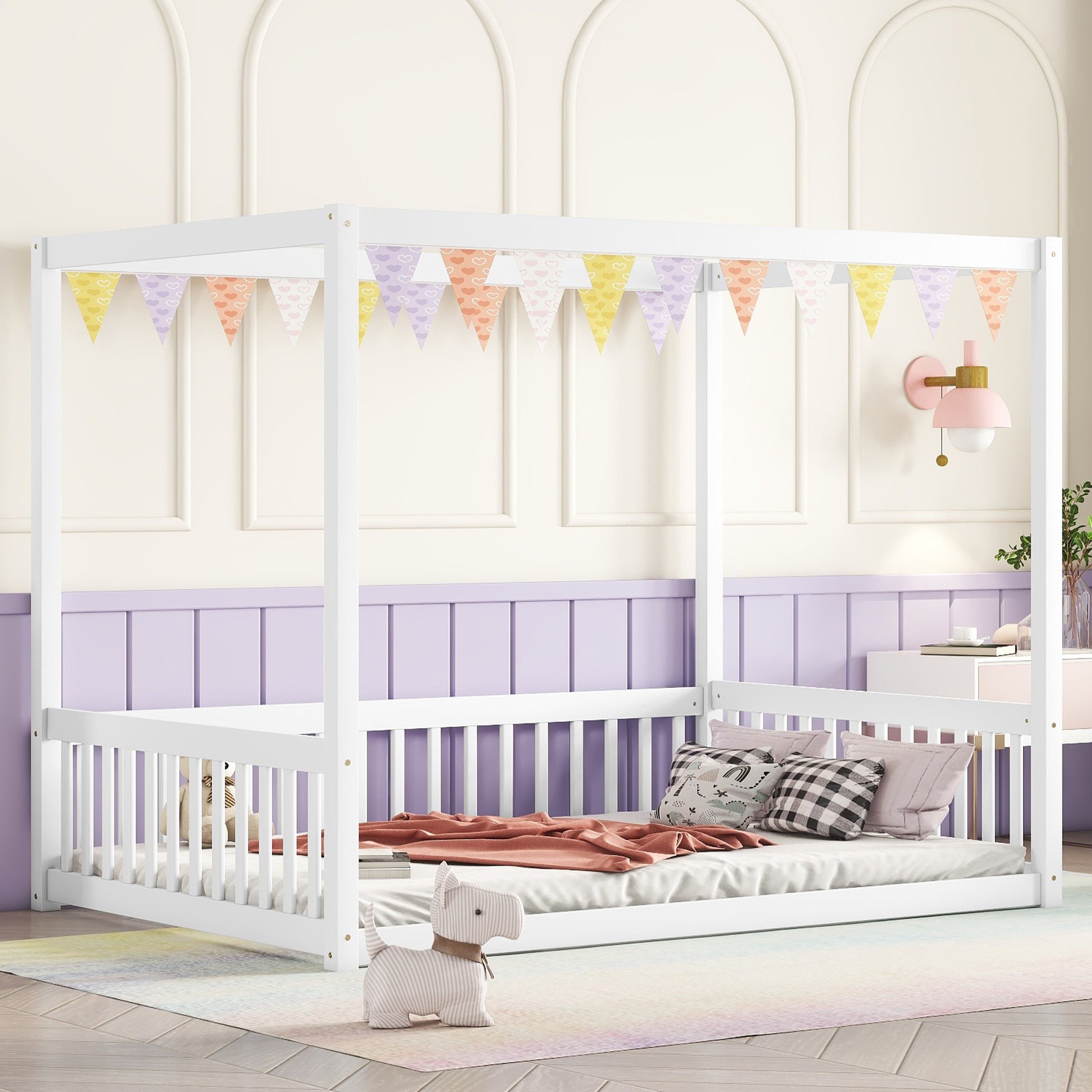 White wooden four poster bed with pastel heart garland