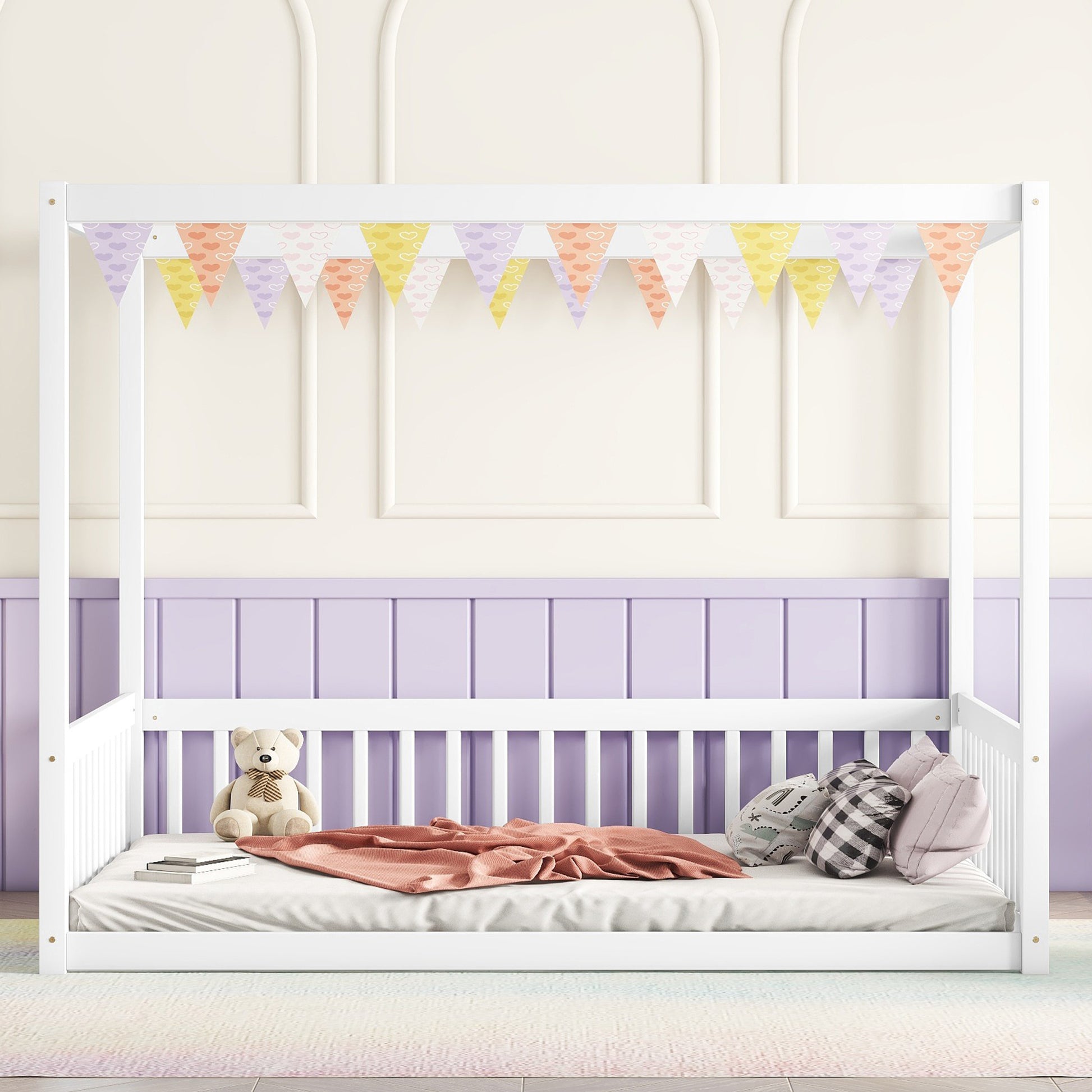 White wooden canopy bed frame with pastel heart bunting