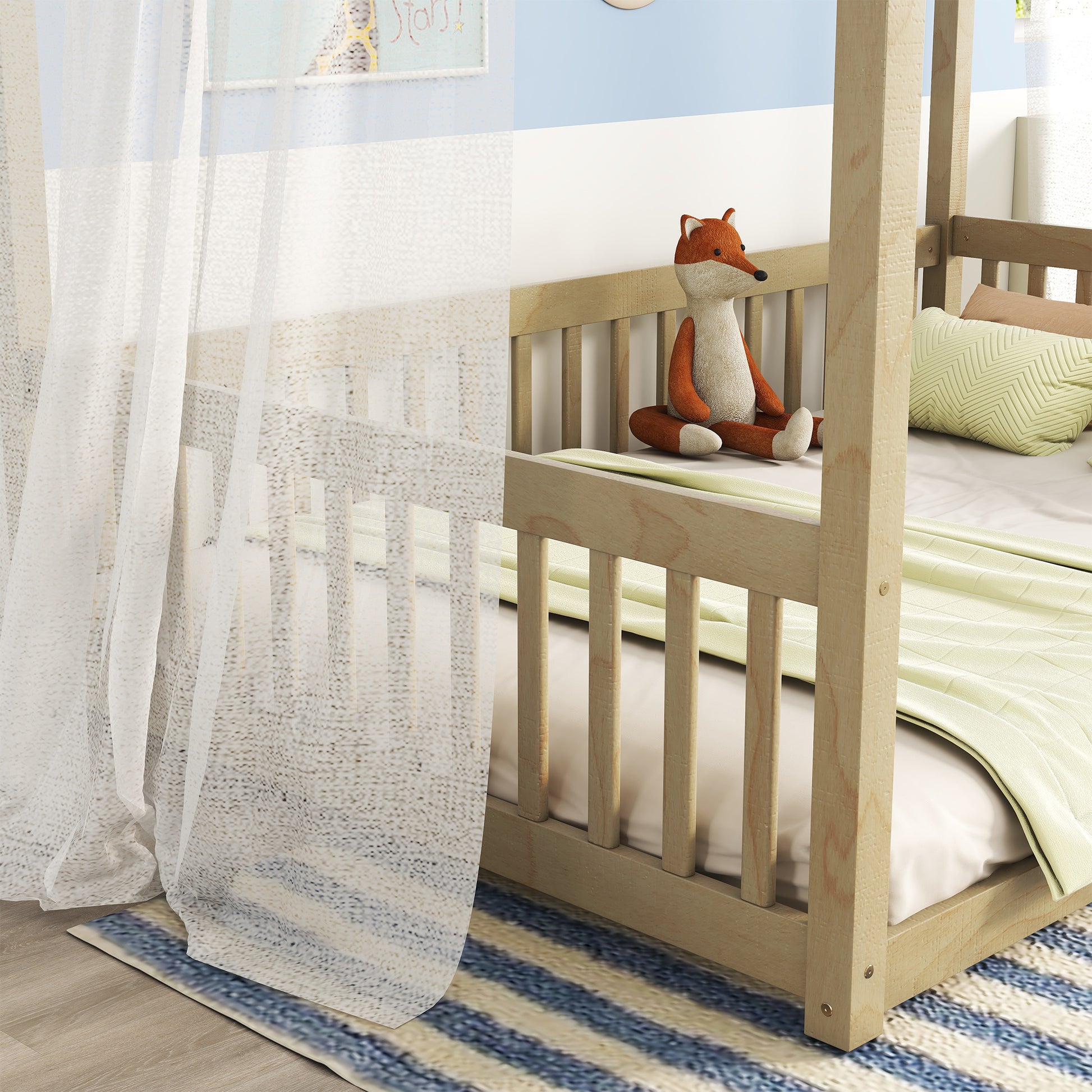Natural wood crib with attached fox toy and light green blanket