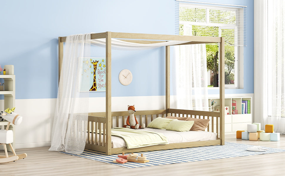 Wooden fourposter toddler bed with white sheer canopy and striped rug