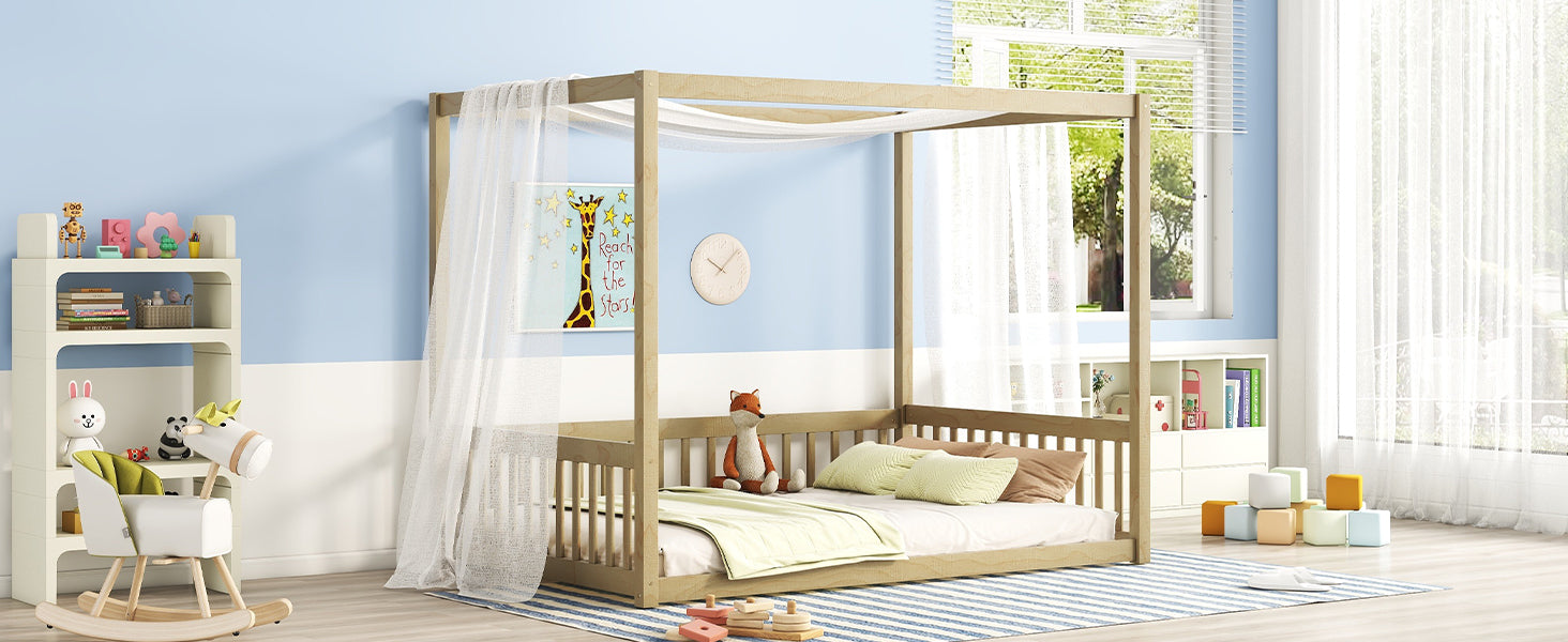 Natural wood fourposter toddler bed with sheer canopy and bedding