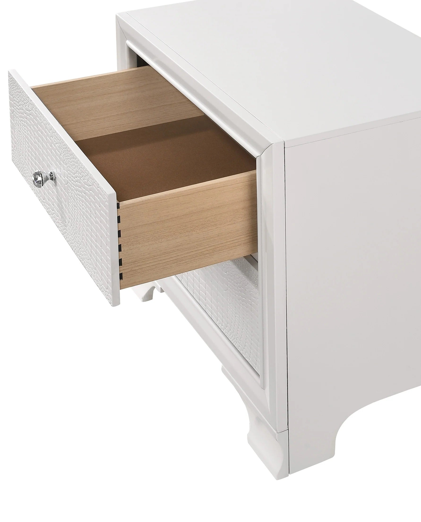 Closeup of a white crocodile embossed drawer front on a bedside table with crystal knob