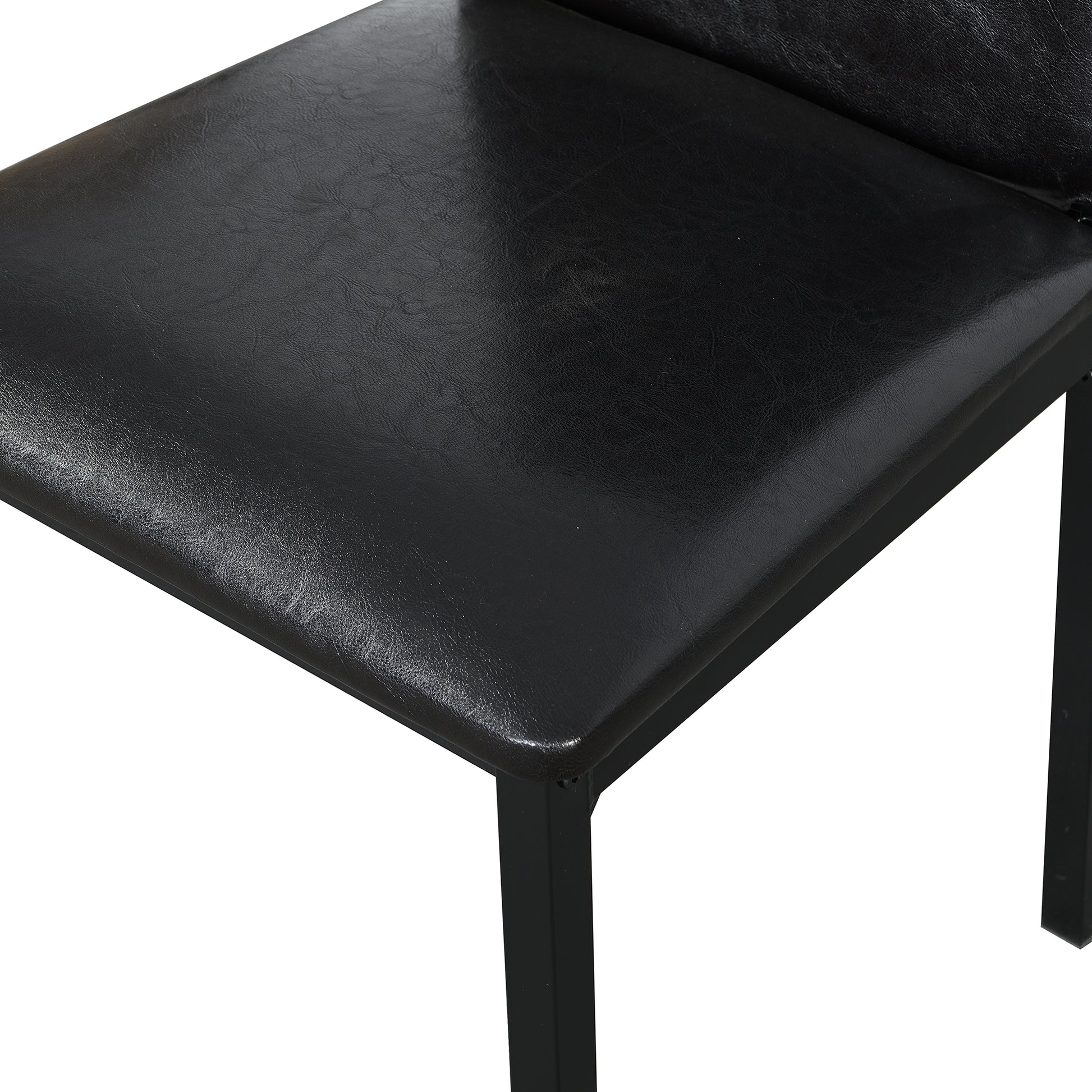 Close up of a black faux leather seat with a metal frame