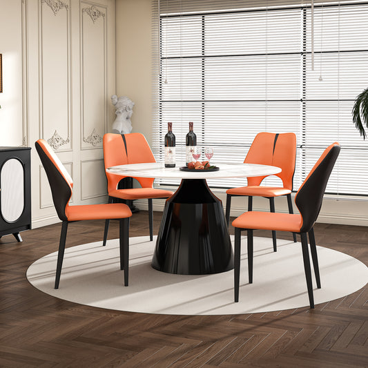Orange and black accent dining chairs with a marbletop round dining table