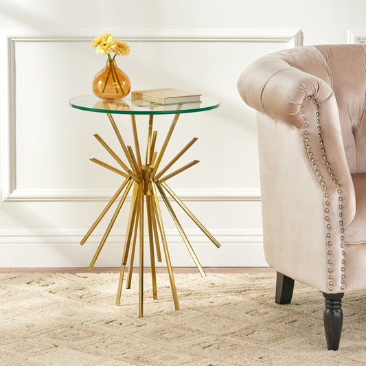 Sleek gold metal side table with a round glass top and starburst base Perfect accent for modern living rooms