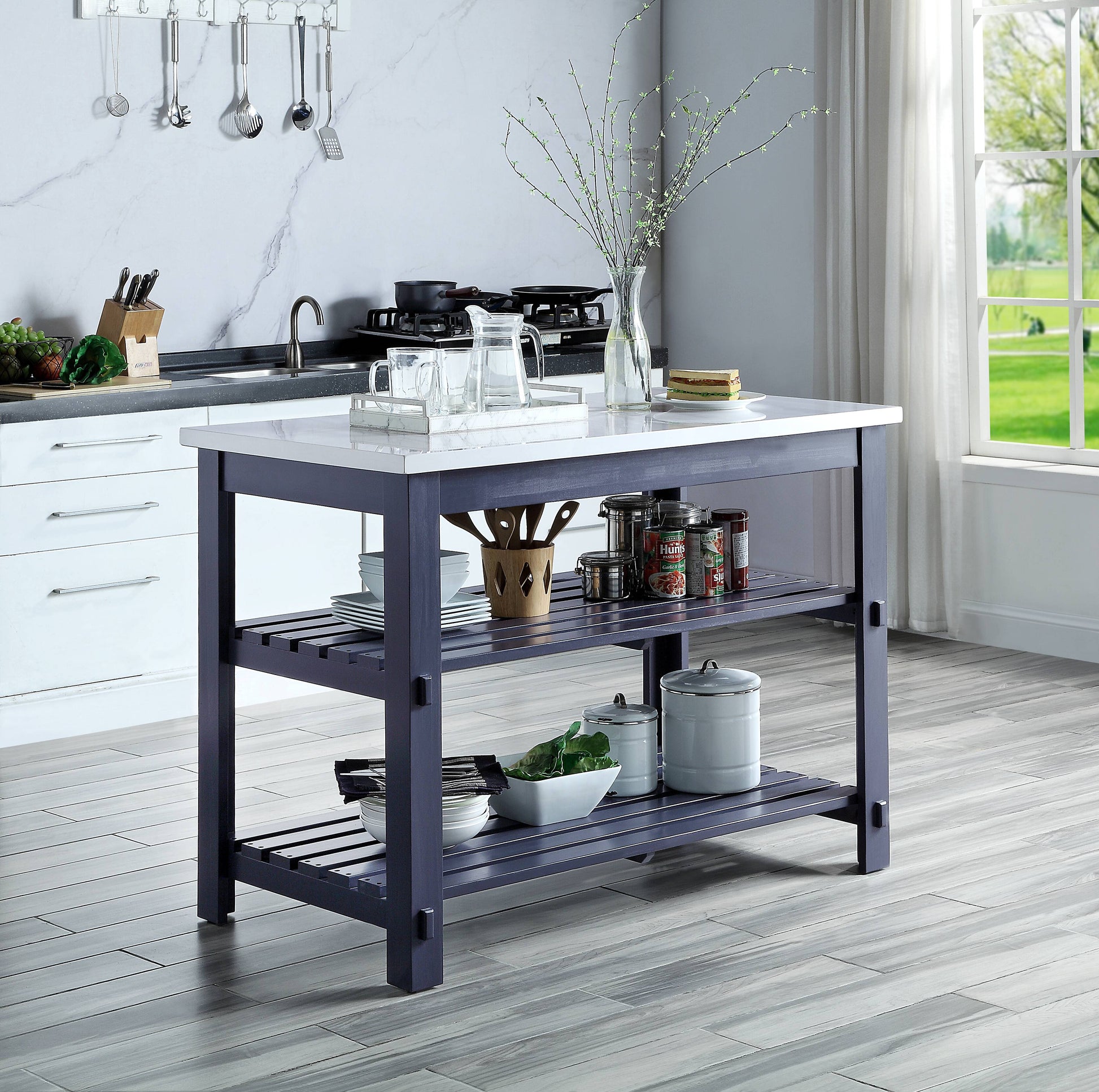 Navy blue kitchen island with white marble top and slatted shelves