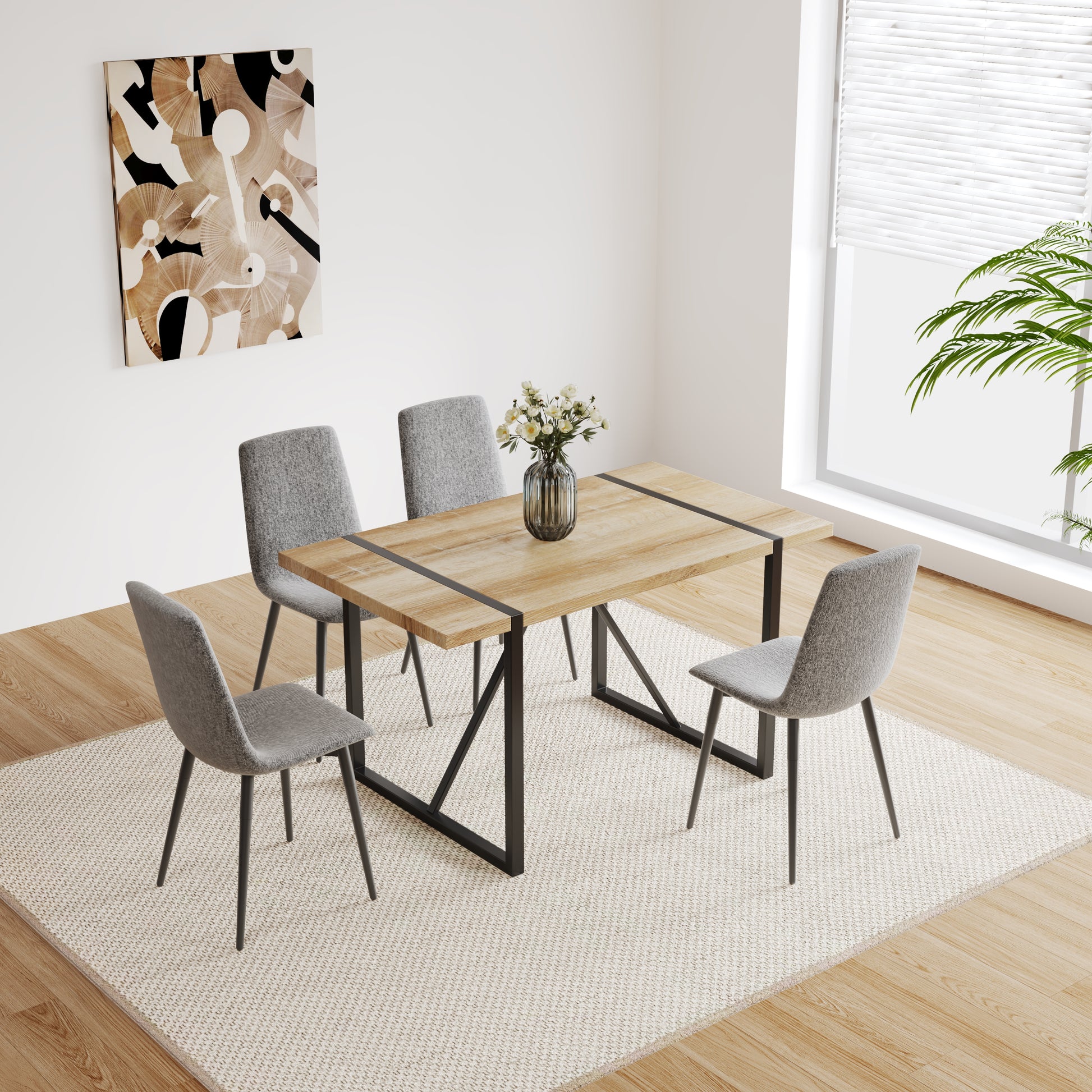 Wooden dining table with black metal legs and four grey fabric chairs