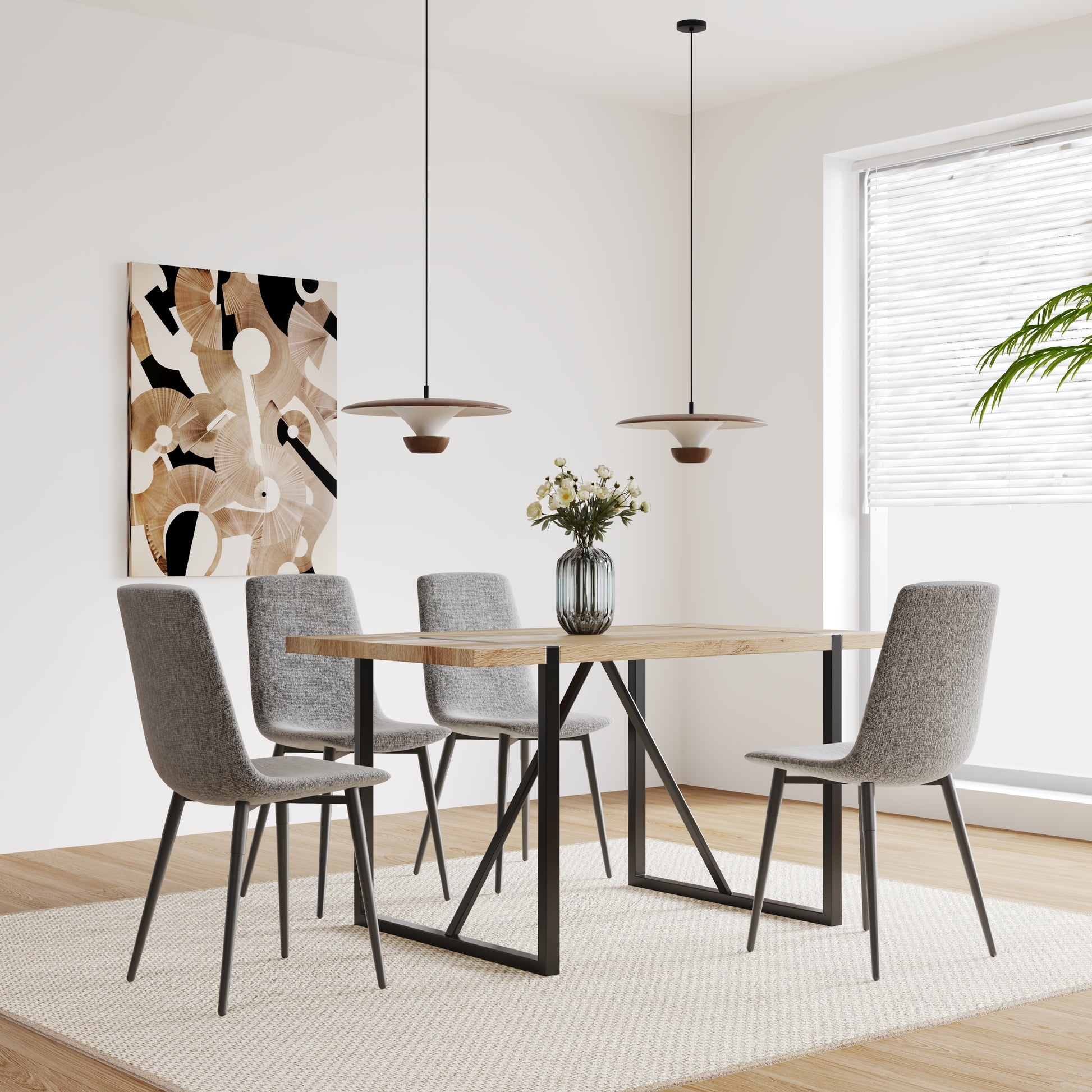 Modern dining chairs with grey fabric and black metal legs around a light wood table