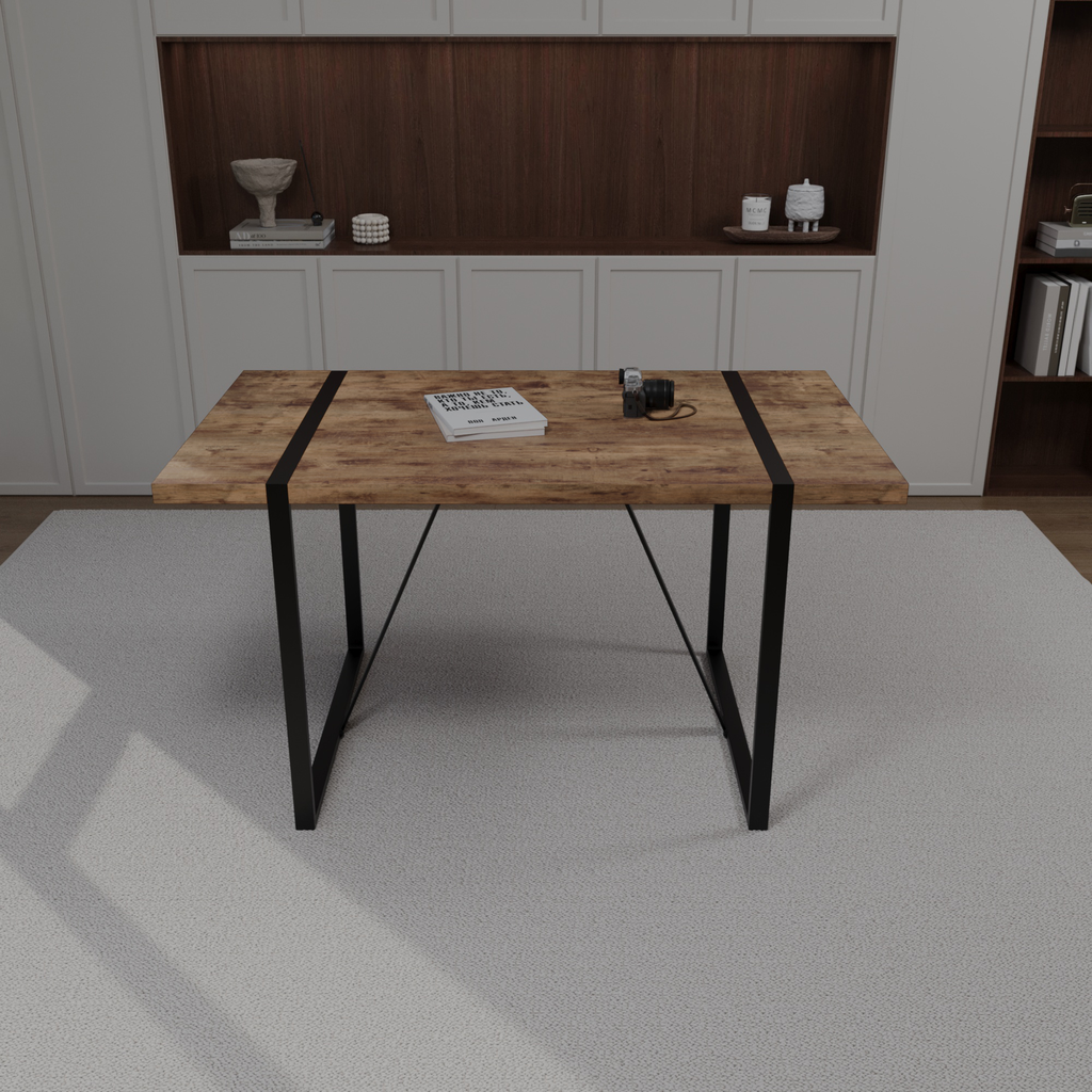 Rustic wood dining table with black metal legs and a book