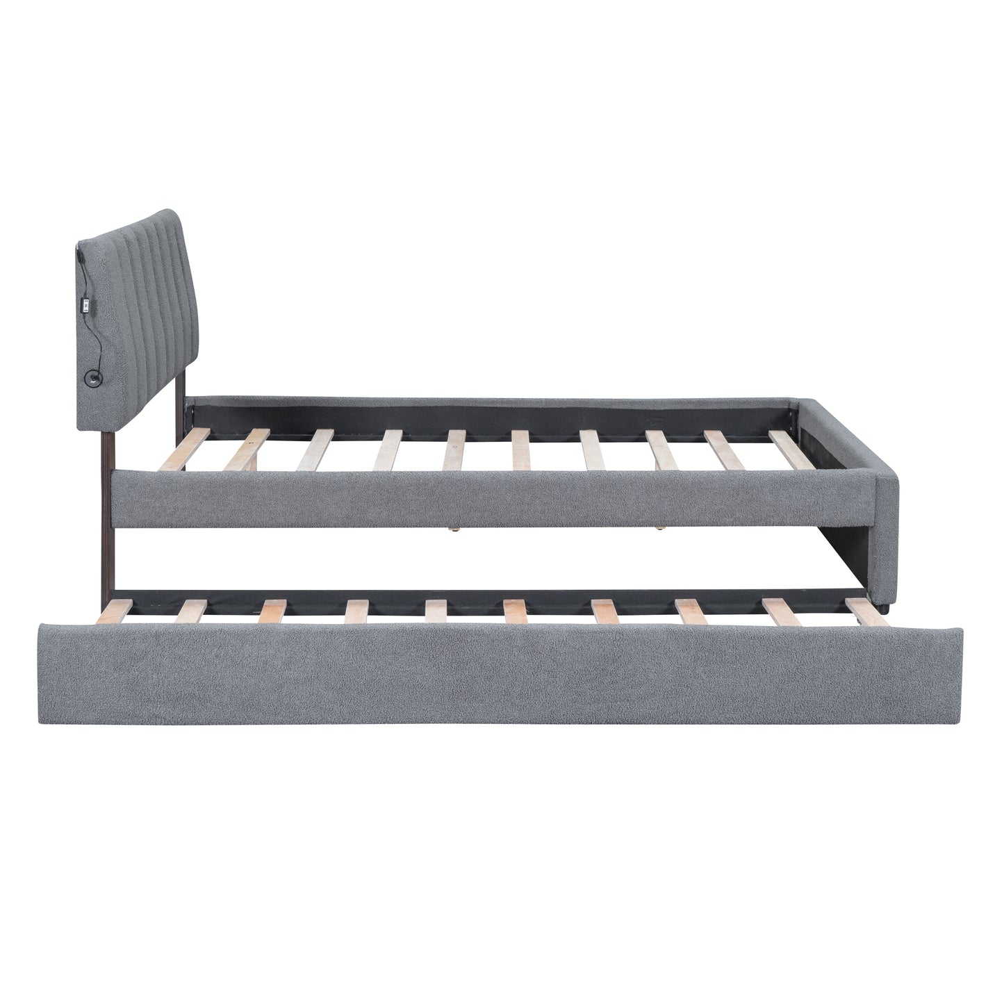 Grey upholstered daybed with pullout trundle and integrated USB ports