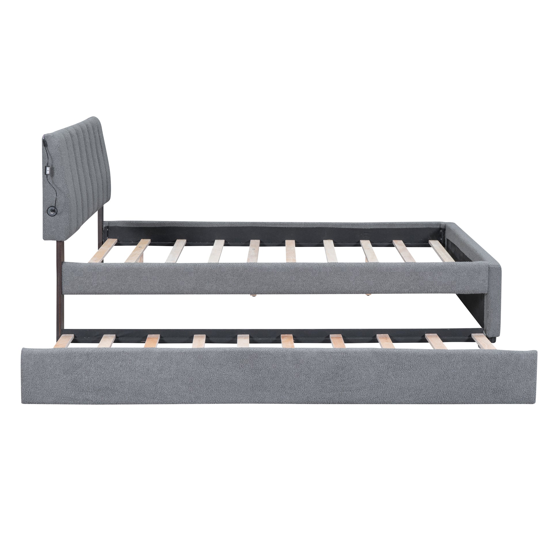 Grey upholstered daybed with pullout trundle and integrated USB ports
