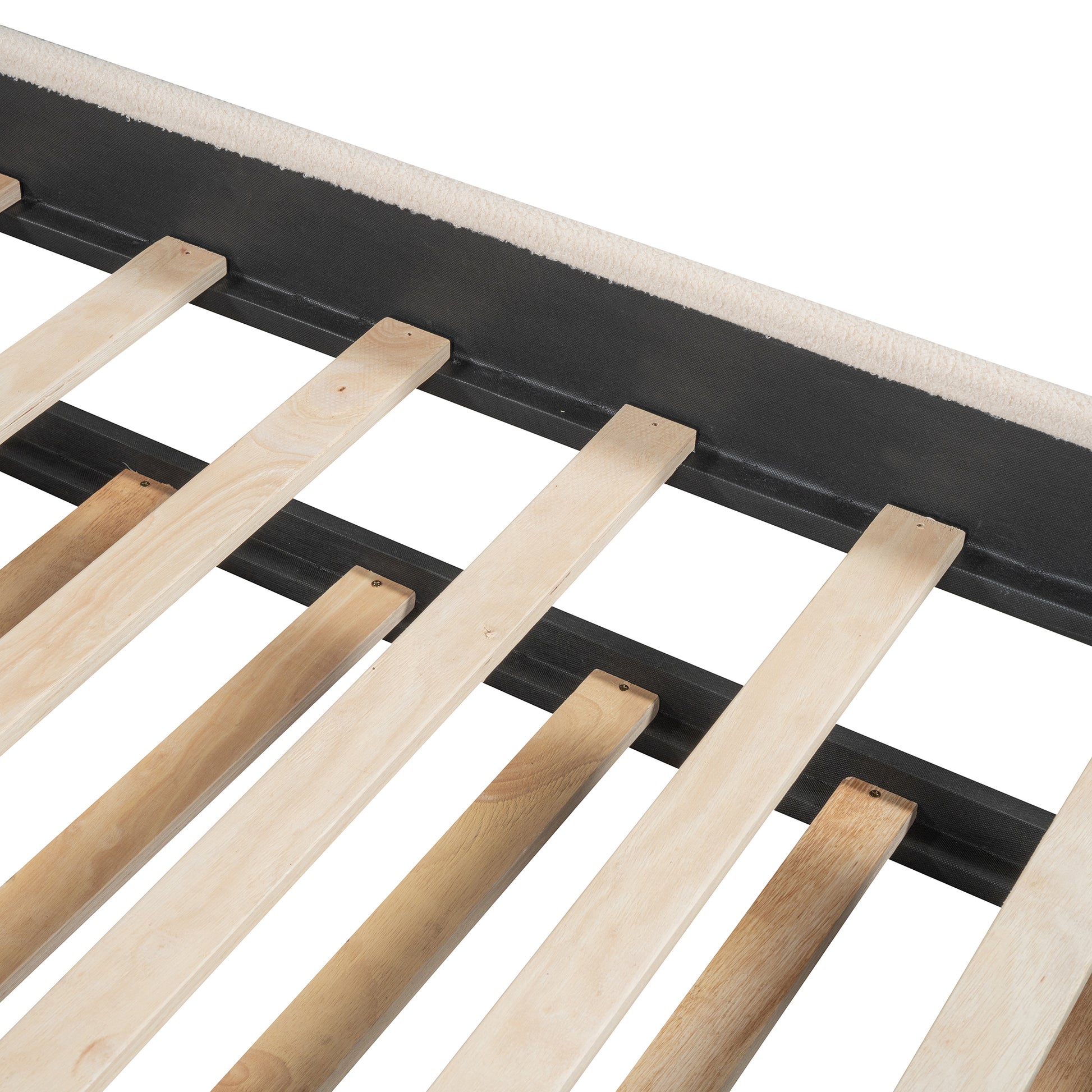 Wooden slat bed frame detail with beige upholstery