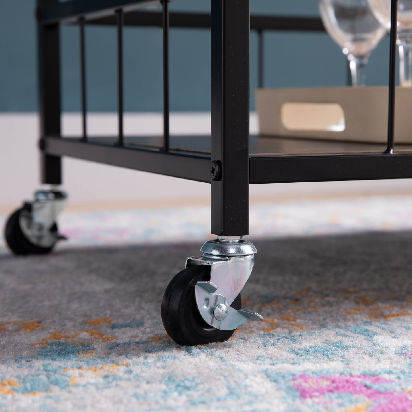 Black metal bar cart with rolling casters