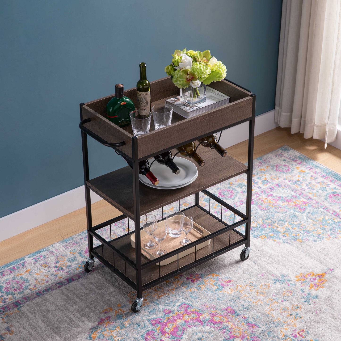 Dark wood and metal bar cart with wine bottles and glasses