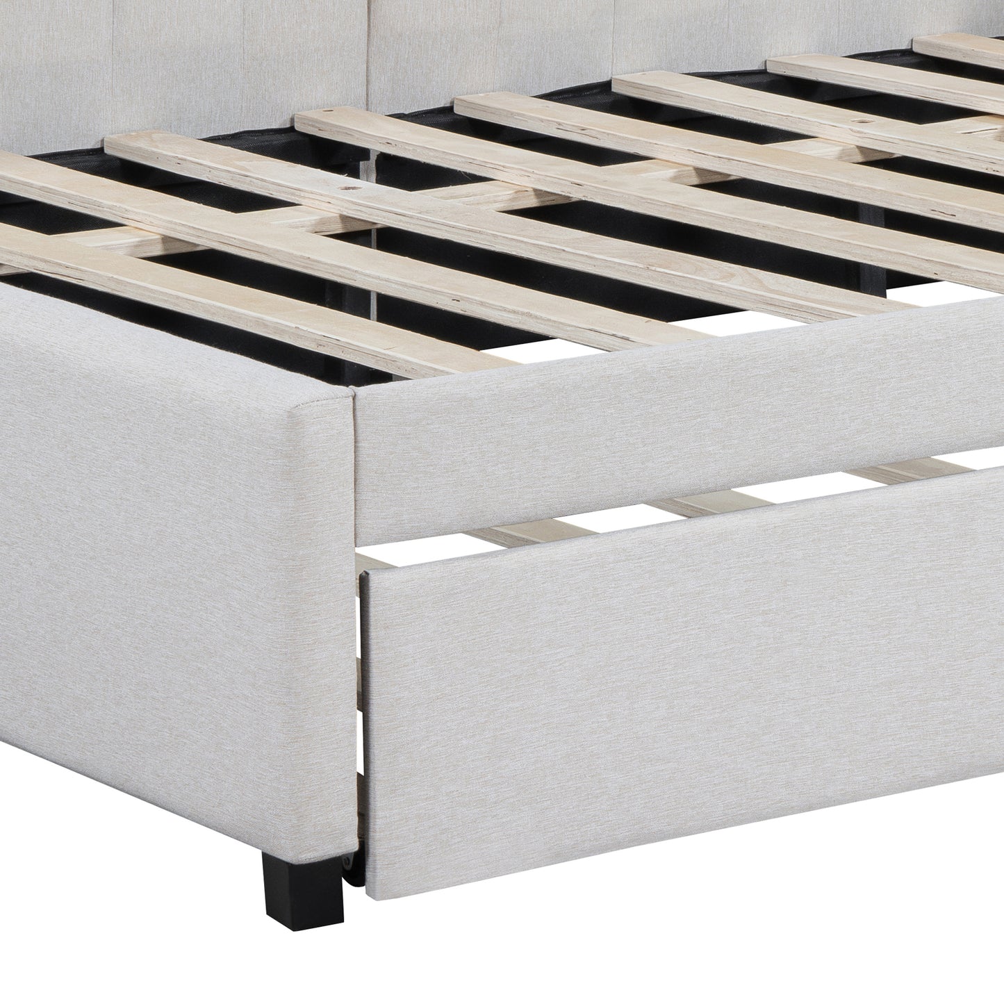 Closeup view of a beige upholstered bed frame with wooden slats
