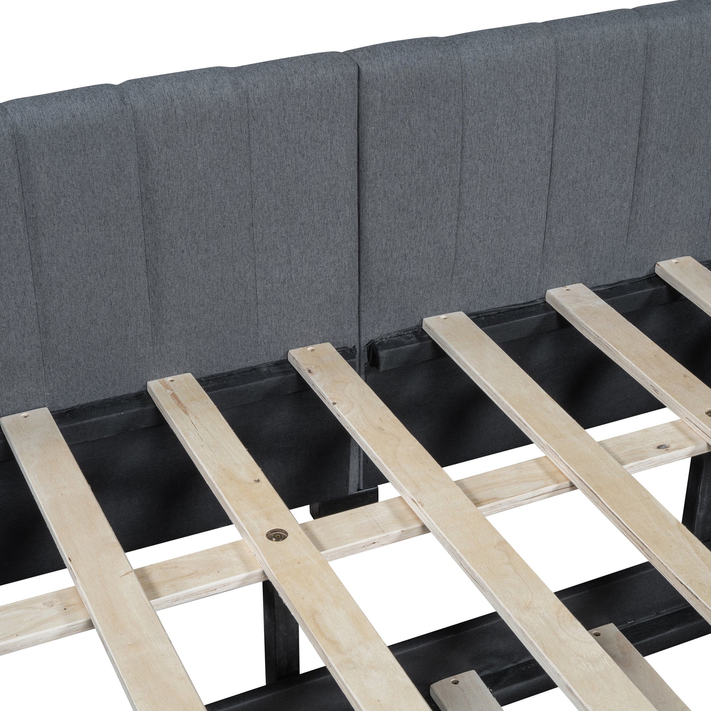 Closeup of upholstered gray fabric headboard