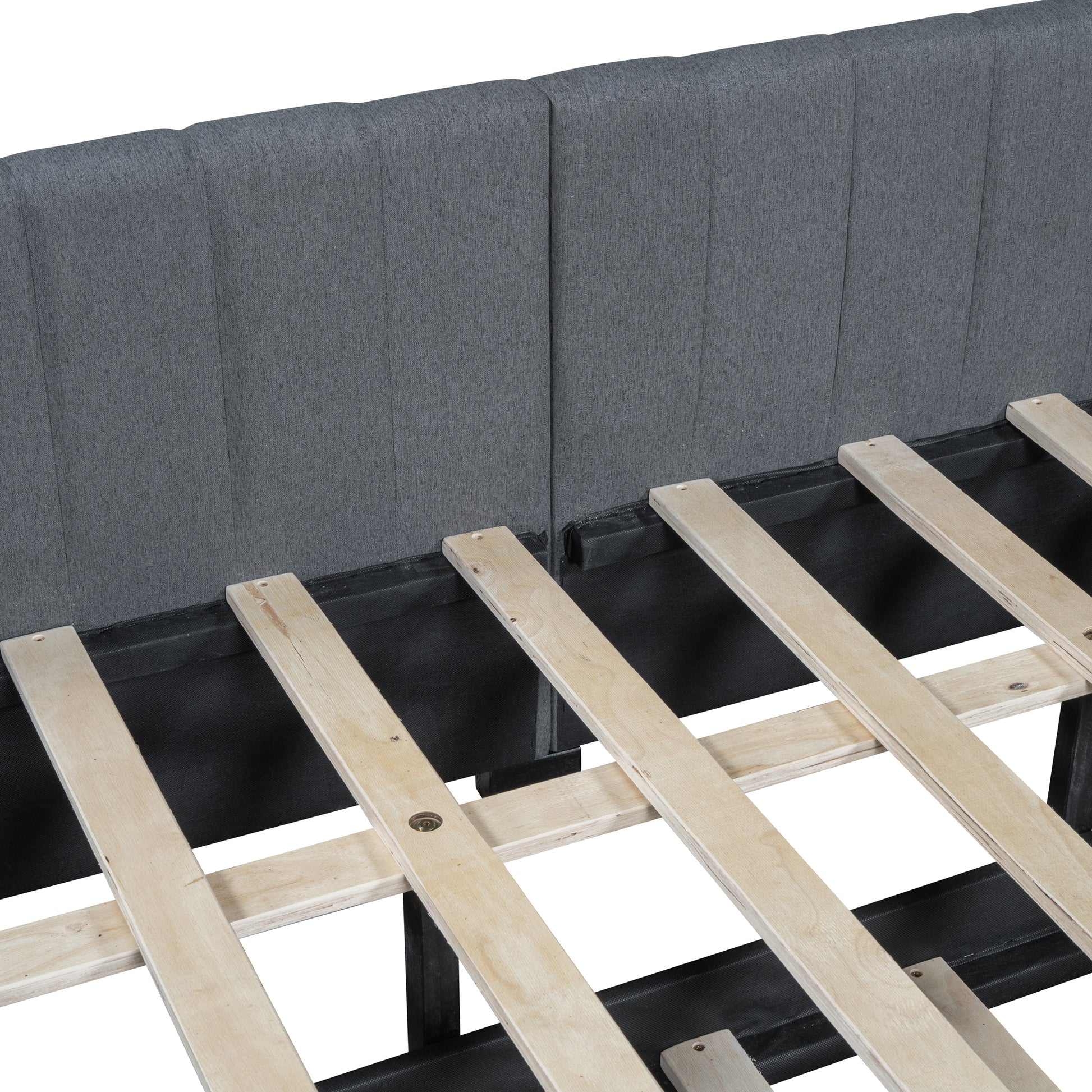 Closeup of upholstered gray fabric headboard