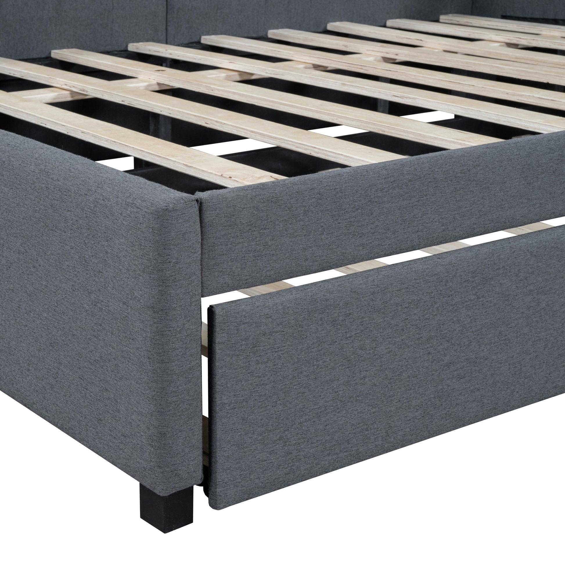 Dark grey upholstered bed frame showing wooden slats