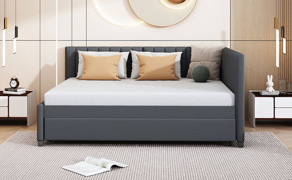 Dark grey upholstered daybed with white mattress and two mustard throw pillows