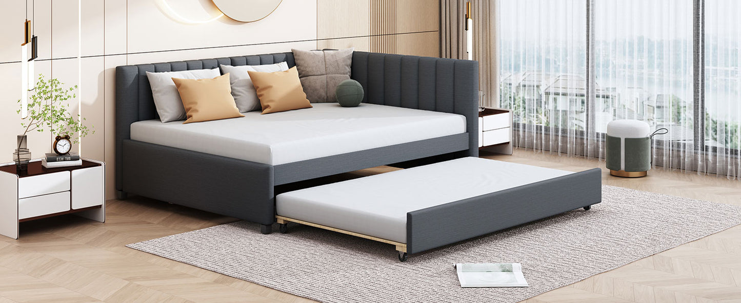Dark gray upholstered daybed with pullout trundle ideal for guest rooms and small spaces