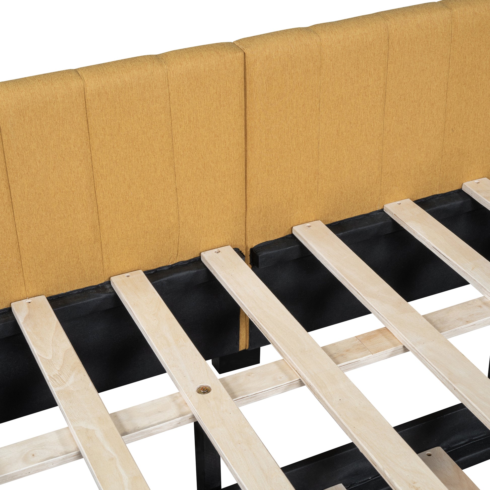 Closeup of mustard yellow upholstered headboard with a wooden slat bed frame