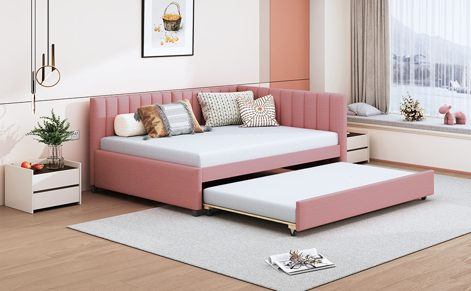 Pink velvet daybed with trundle featuring tufted headboard and accent pillows