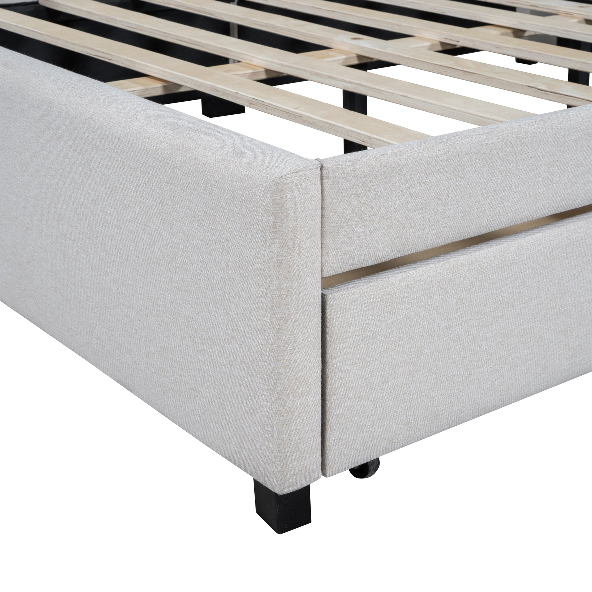 Closeup of a beige upholstered bed frame with wooden slats