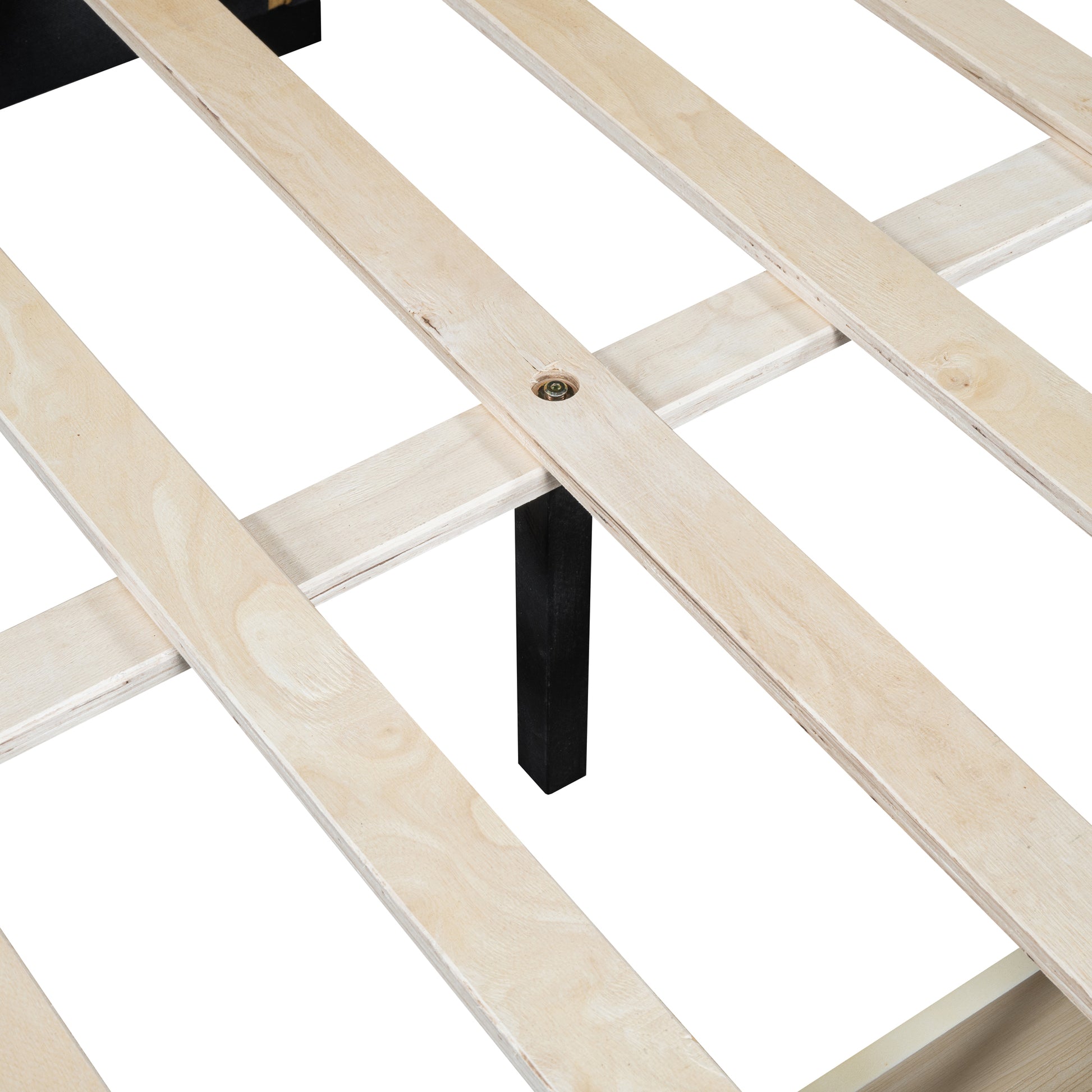 Closeup of natural wood bed slats with a black support leg