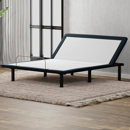 Dark blue upholstered adjustable bed frame with silver guardrail on shag rug