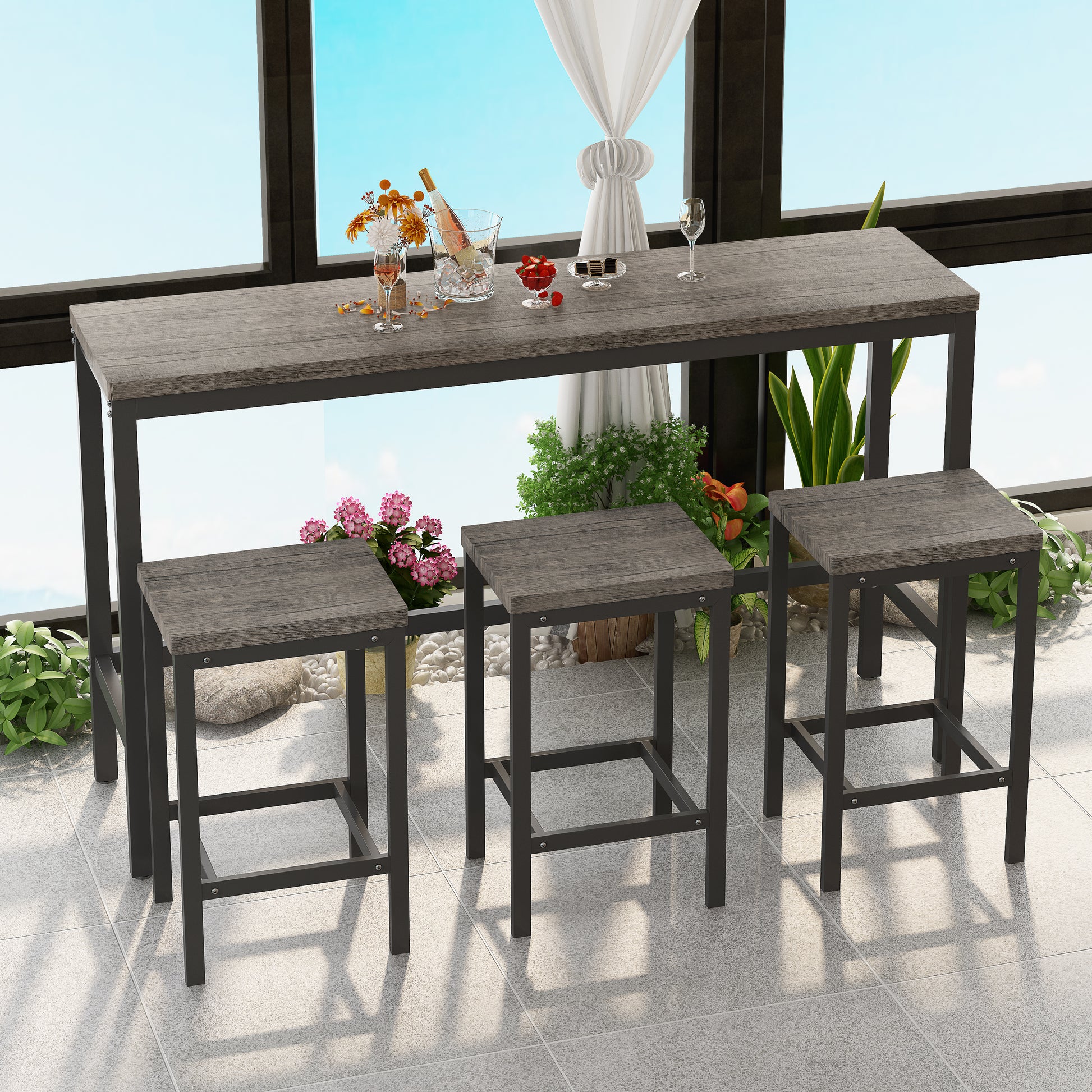 Gray wood grain and black metal pub table set with three stools on a balcony