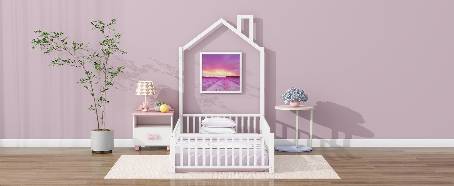 White wooden houseshaped toddler bed with purple bedding
