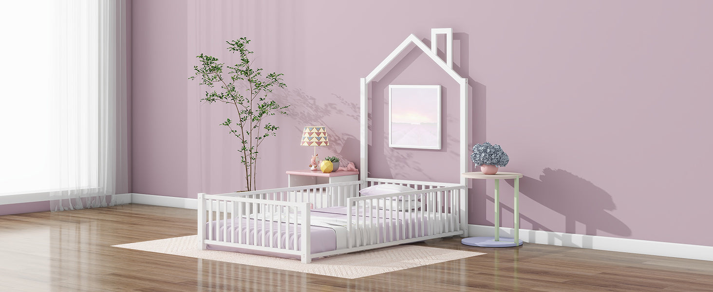 White wooden toddler bed with pastel bedding and a houseshaped frame
