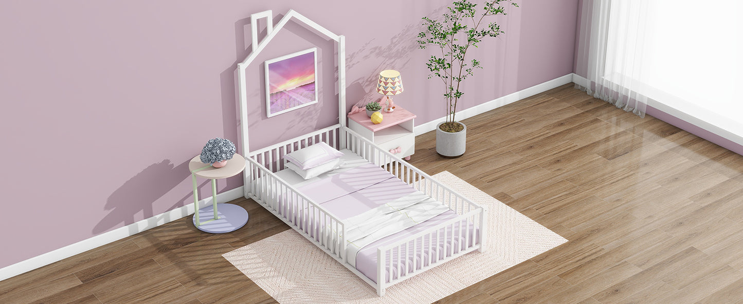 White wooden toddler bed with house frame and pastel bedding