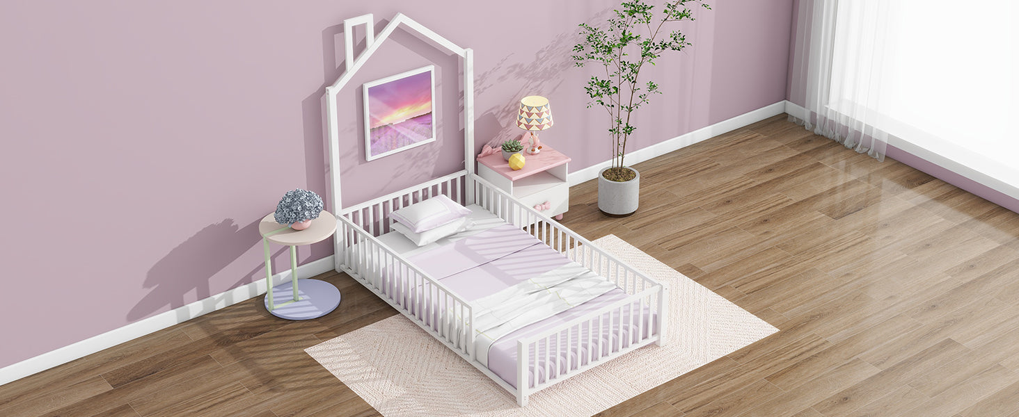 White wooden toddler bed with house frame and pastel bedding