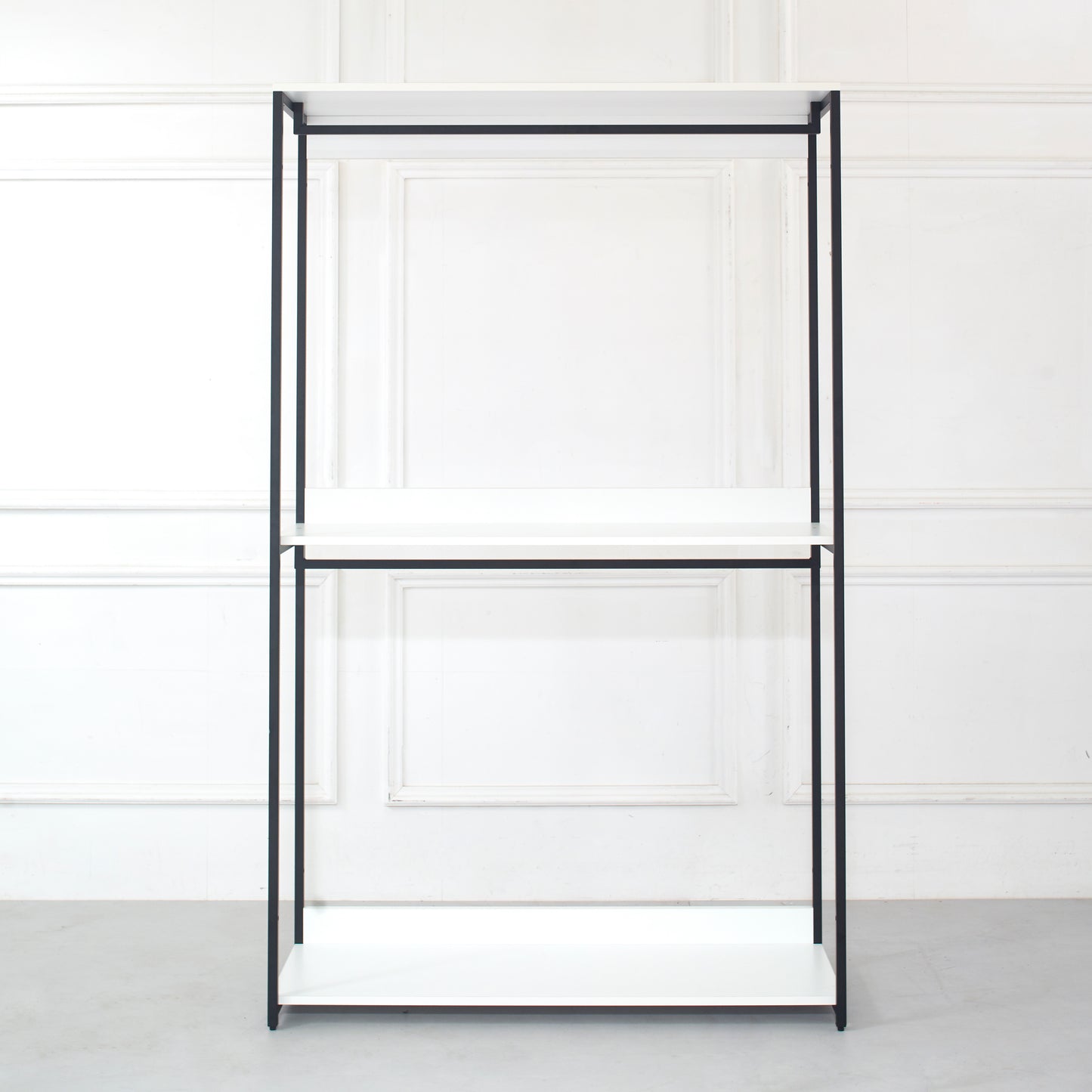 Minimalist black metal frame shelving unit with three white shelves